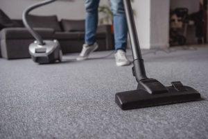 Vacuuming carpet to remove winter grit and salt Northern Michigan