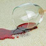 wine glass freshly spilled on white carpet